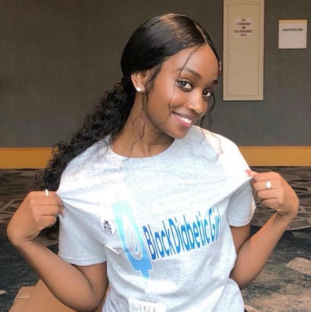 Adeline Umubyeyi, a T1 International activist, models a t-shirt from the group’s Washington, DC chapter president. 